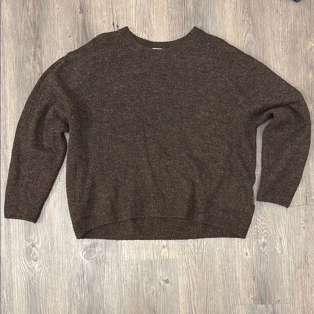 Stay cozy and stylish with this classic brown sweater. Perfect for any occasion.